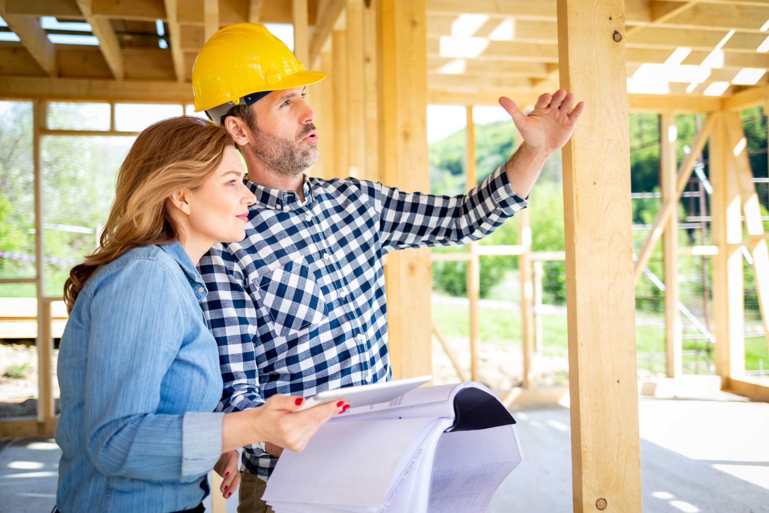 Architect Or Engineer With Blueprints Meeting With Owner Of Building House