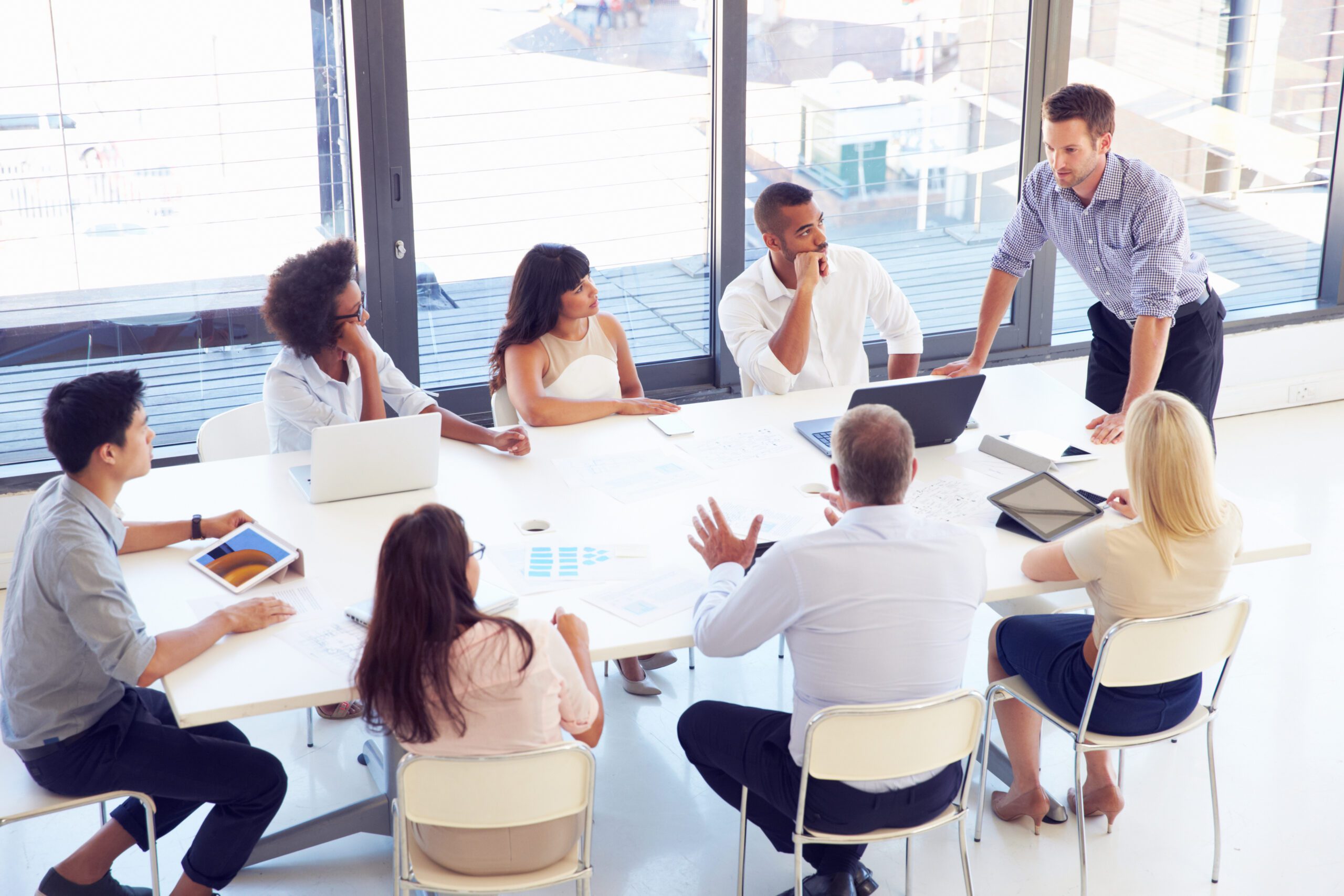 Businessman Presenting To Colleagues At A Meeting